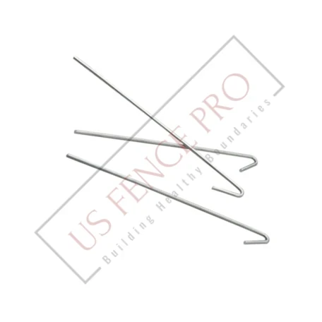 Galvanized steel chain-link fence ties arranged on a plain surface, showing their twisted wire shape and metallic finish, designed for securing fence fabric to posts and rails in outdoor environments, conveying reliability and utility